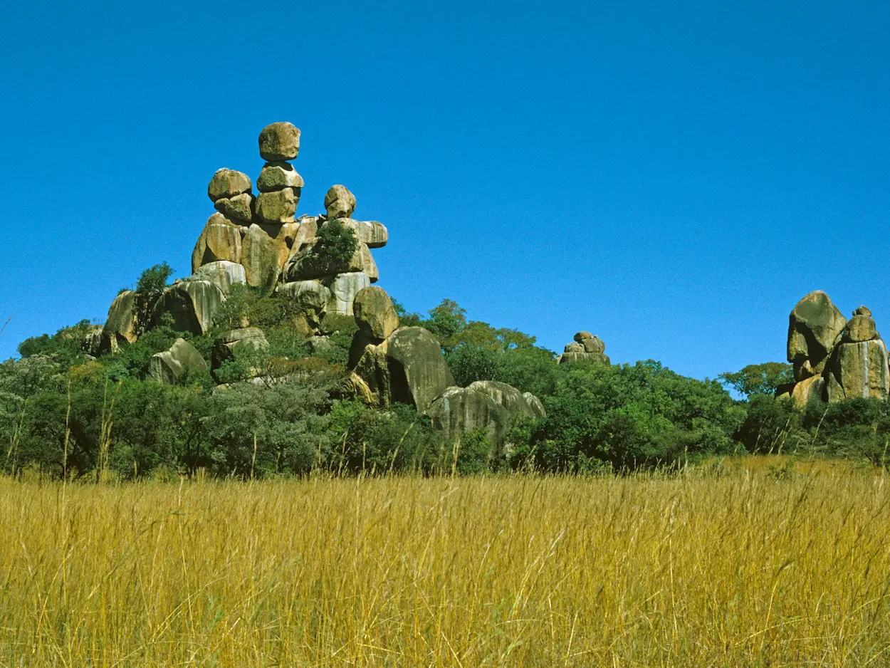 Balancing granite boulders in the sacred Matobo Hills landscape, Zimbabwe, under clear blue skies